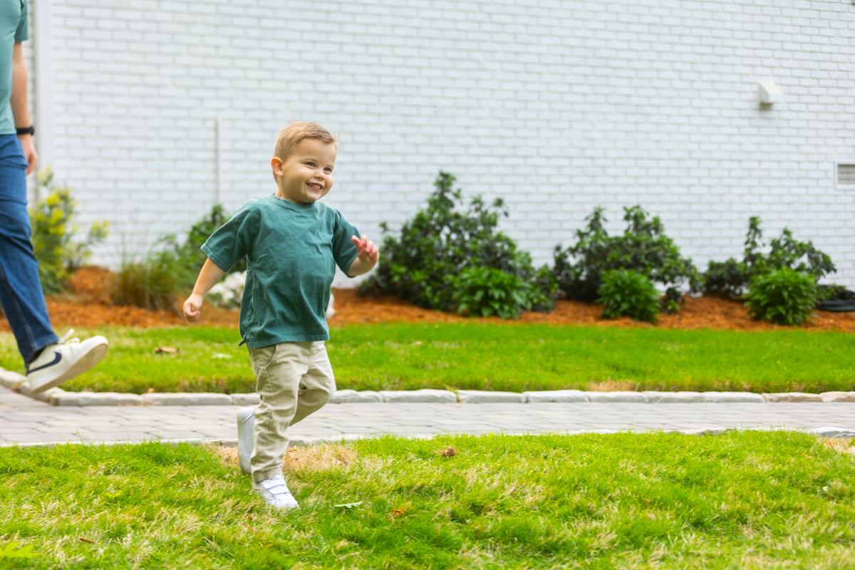 happy kid running through healthy grass