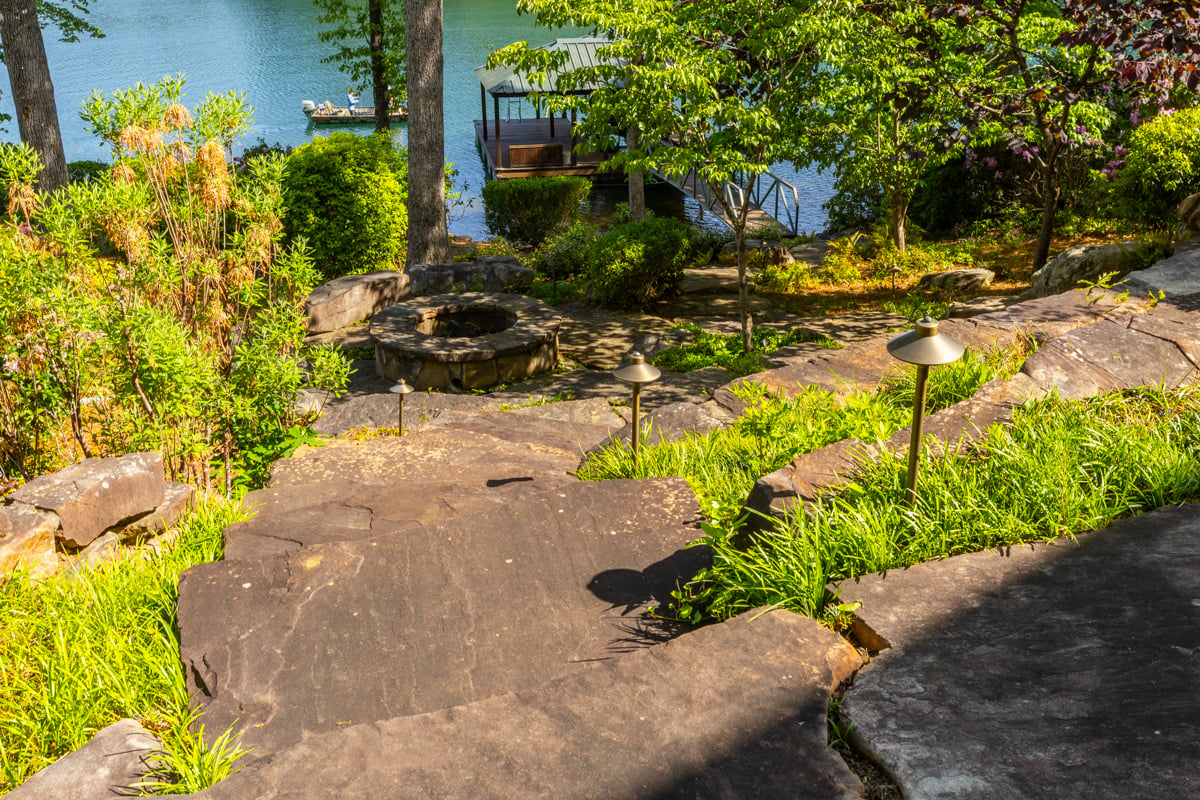 naturalized area with a stone fire pit tucked away
