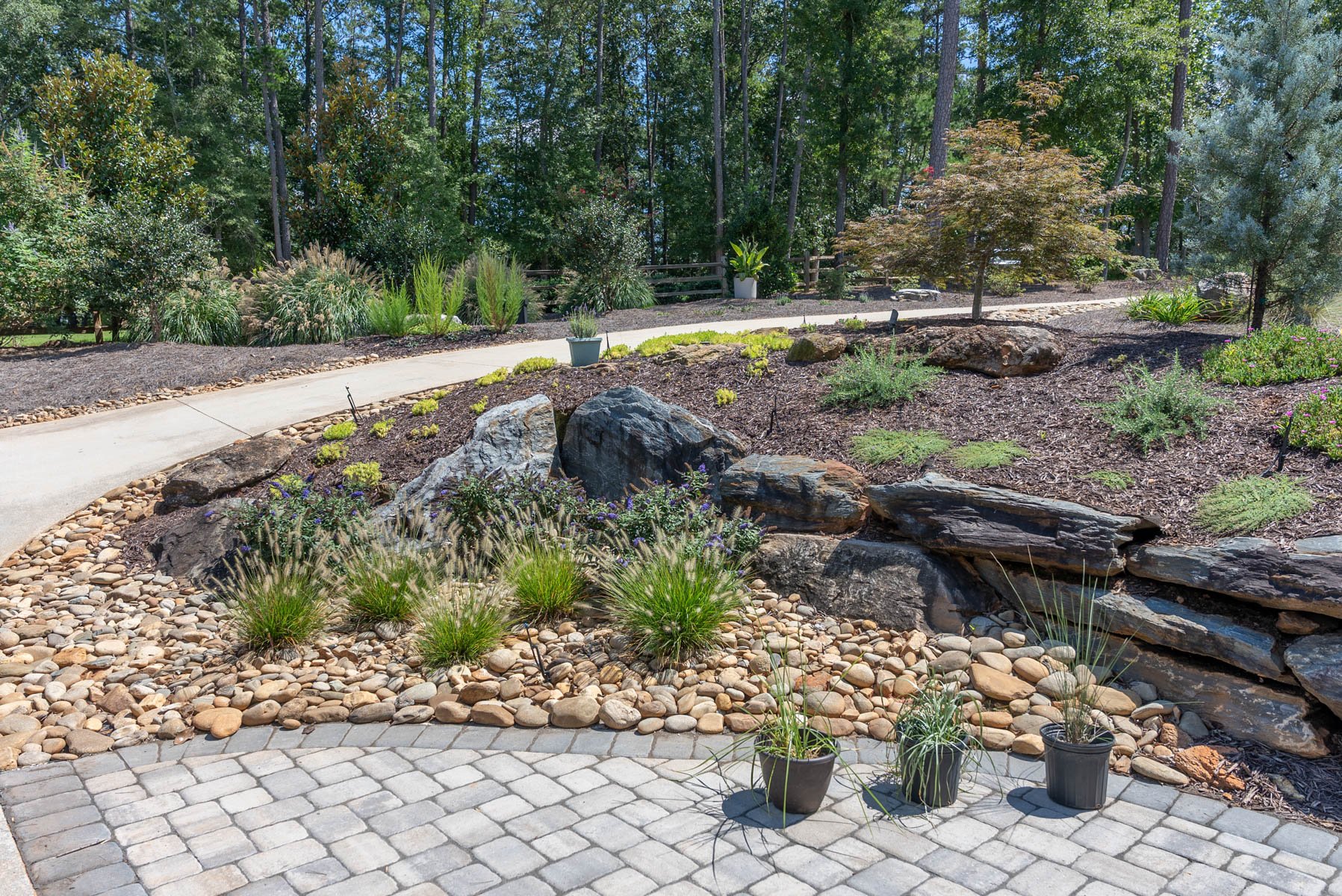 combining rocks and mulch in beds provides visual intrigue
