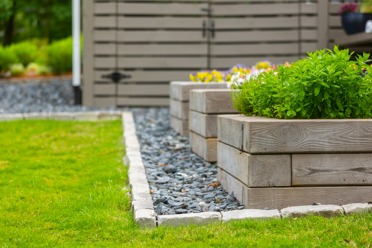 detail paver edge gravel chip raised planter beds flowers herbs grass