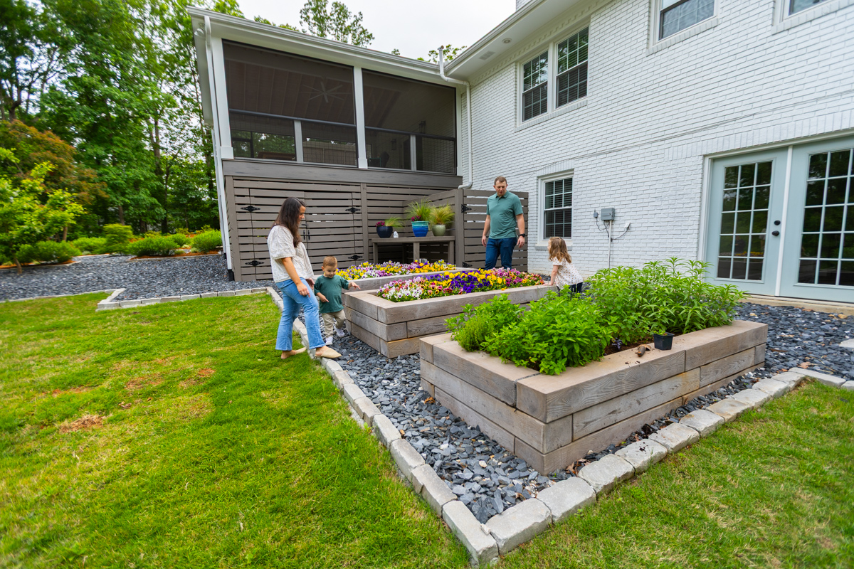 family kids raised garden beds gravel path patio herbs