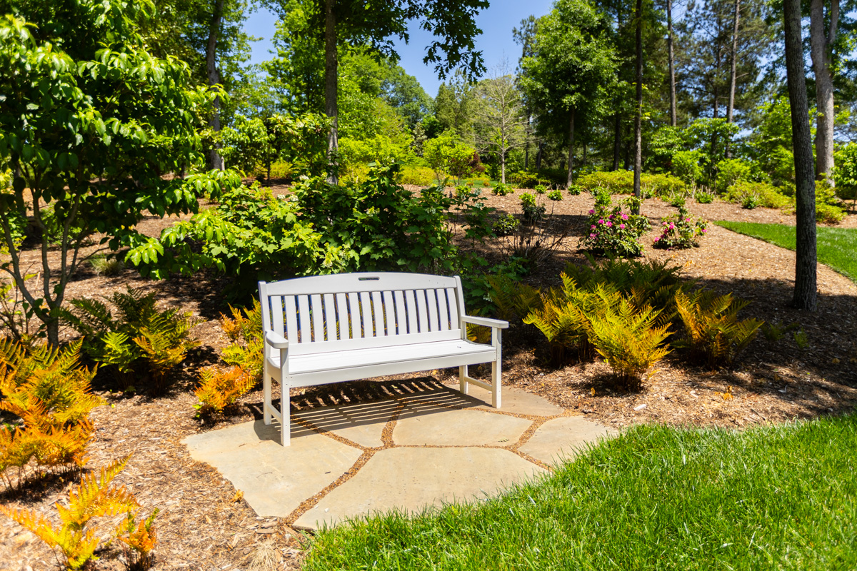 natural stone bench seating area sumac planting bed grass lawn