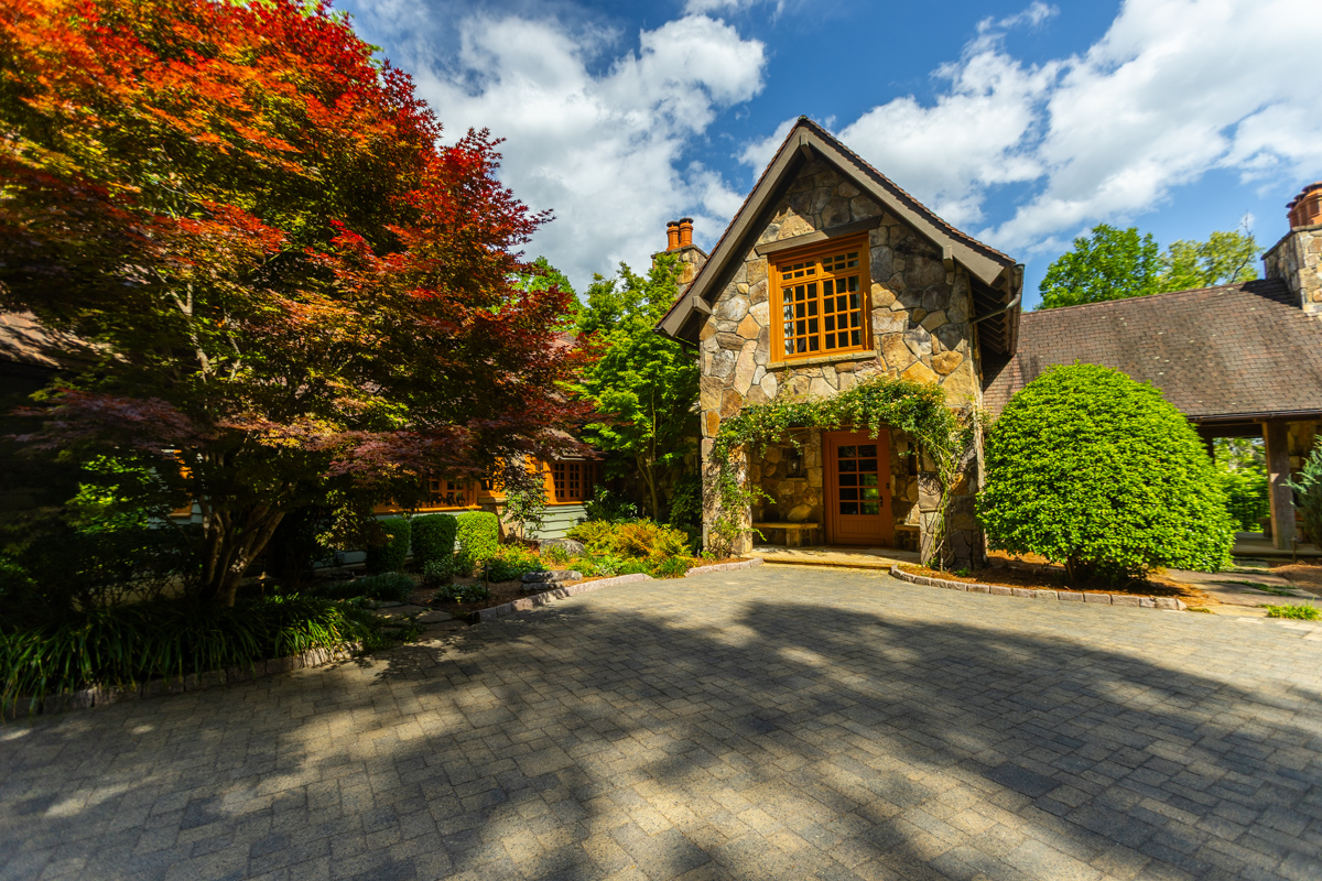 nice front entry tree paver driveway ivy vines stone house