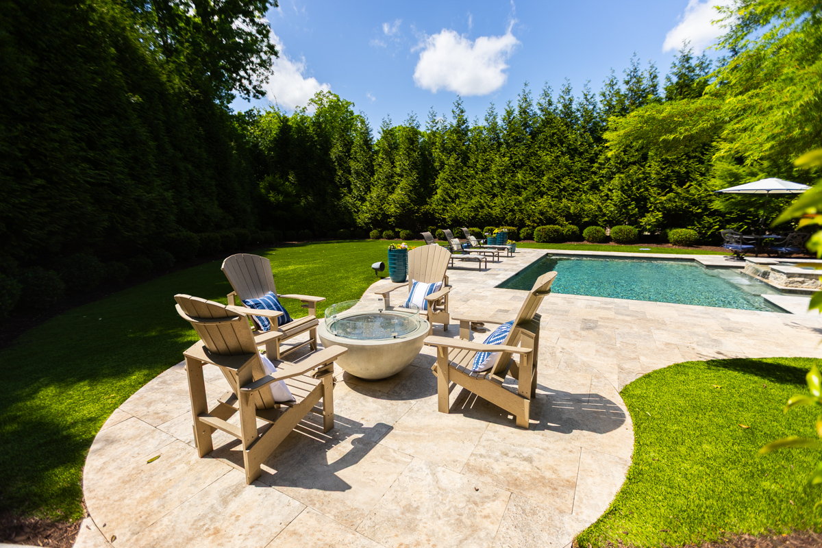 nice pool deck patio firepit chair seating screening plants grass