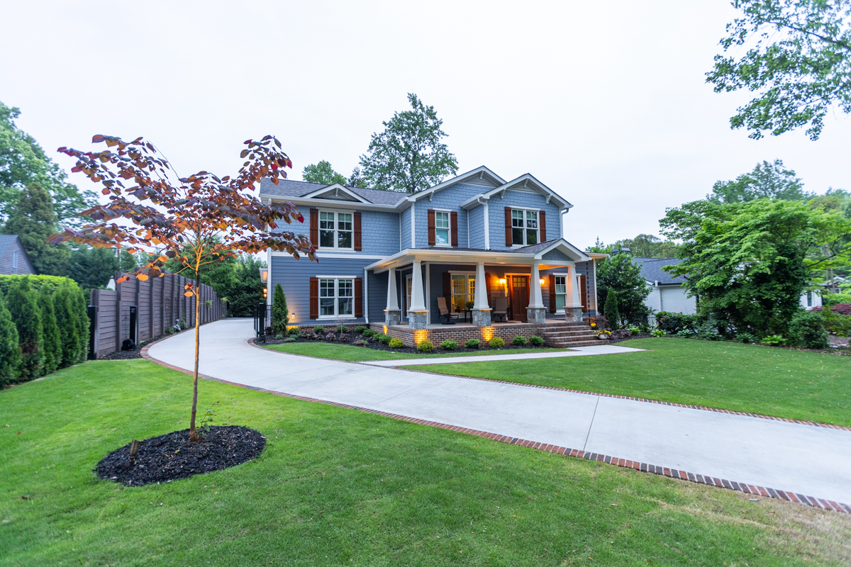 nice tree spot light mulch ring landscape drivewway brick accent front yard