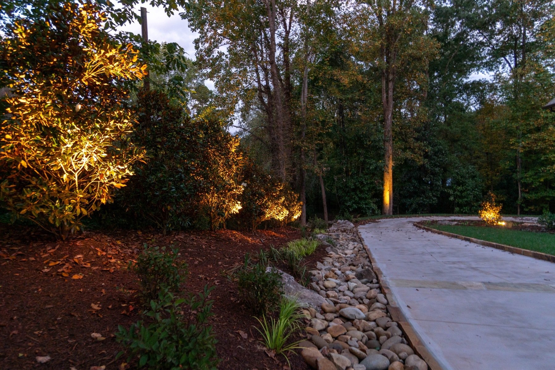 planting bed landscape lighting night uplight cobble drainage driveway