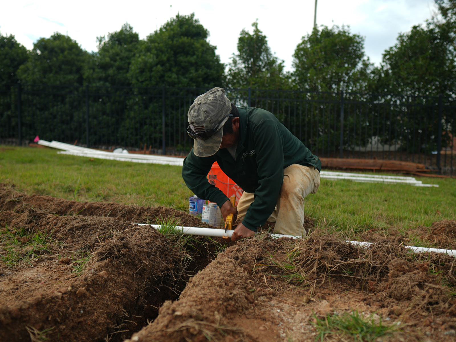 crew irrigation install pipe cutting