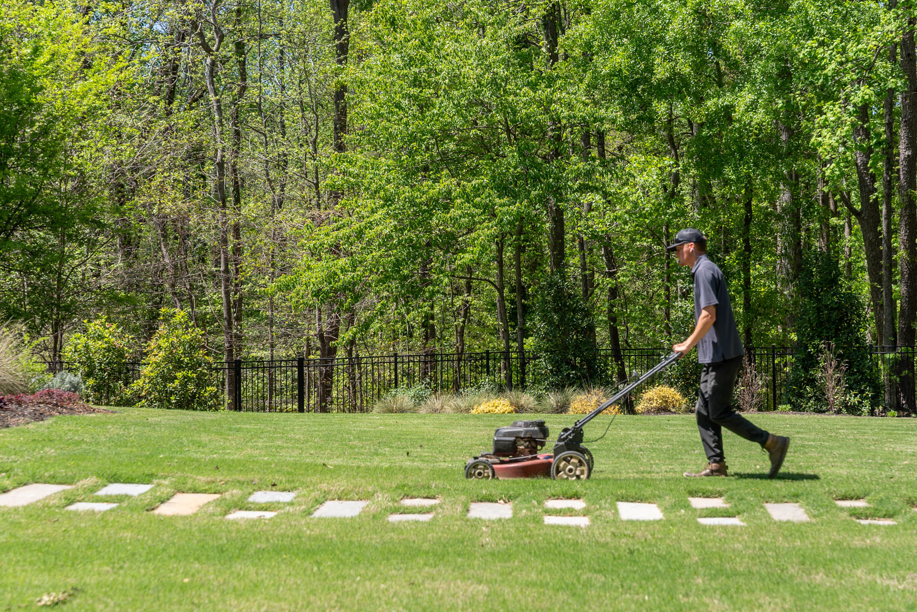 crew maintenance mowing grass lawn stone steppers