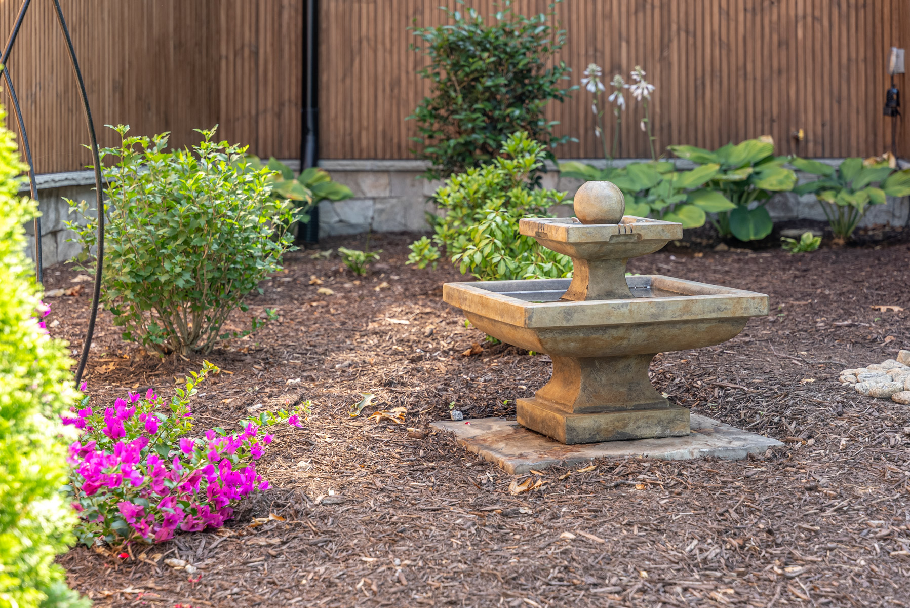 detail planting bed flowers water feature fountain