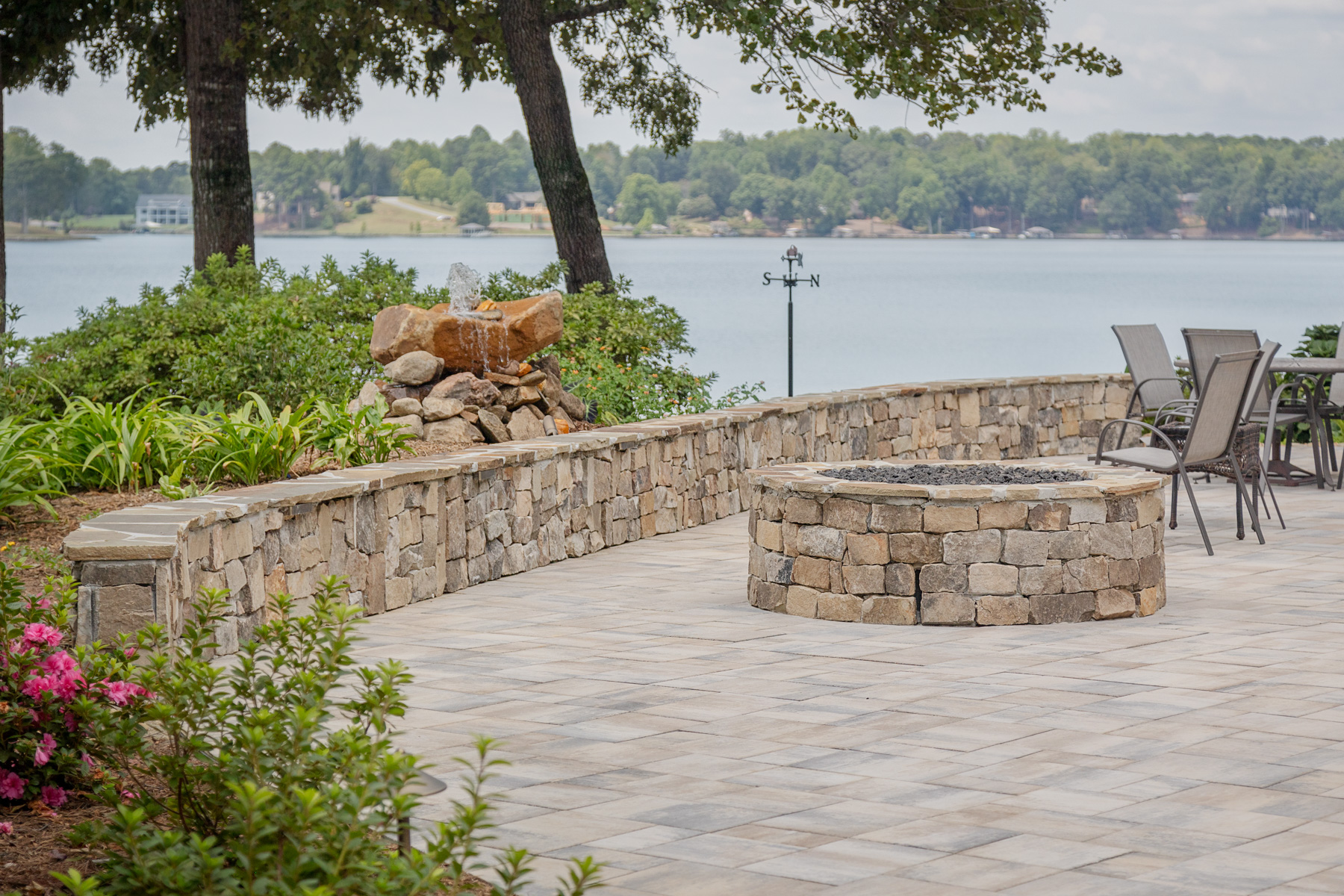 dimensional paver patio stone wall lake mulch planting beds seating fire pit water feature 2