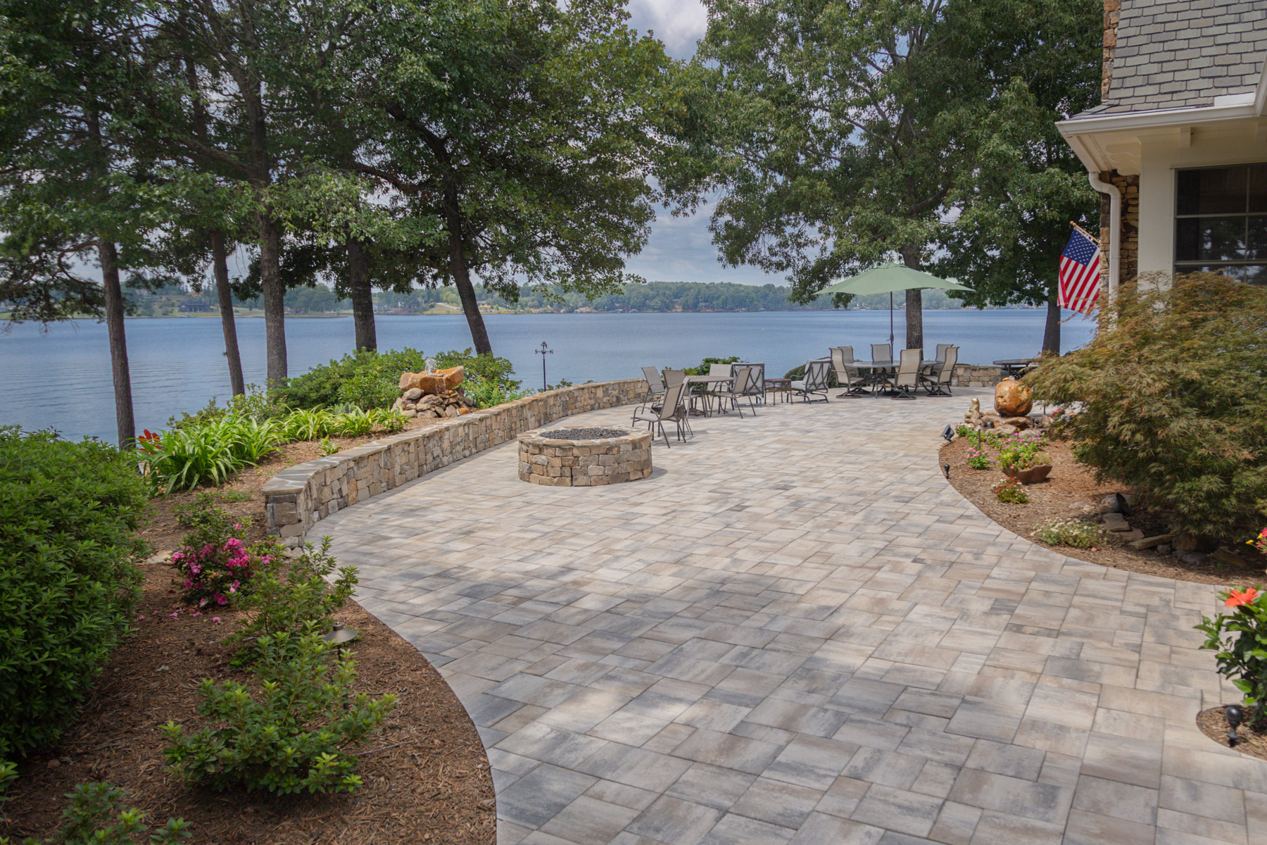 dimensional paver patio stone wall lake mulch planting beds seating fire pit water feature 3