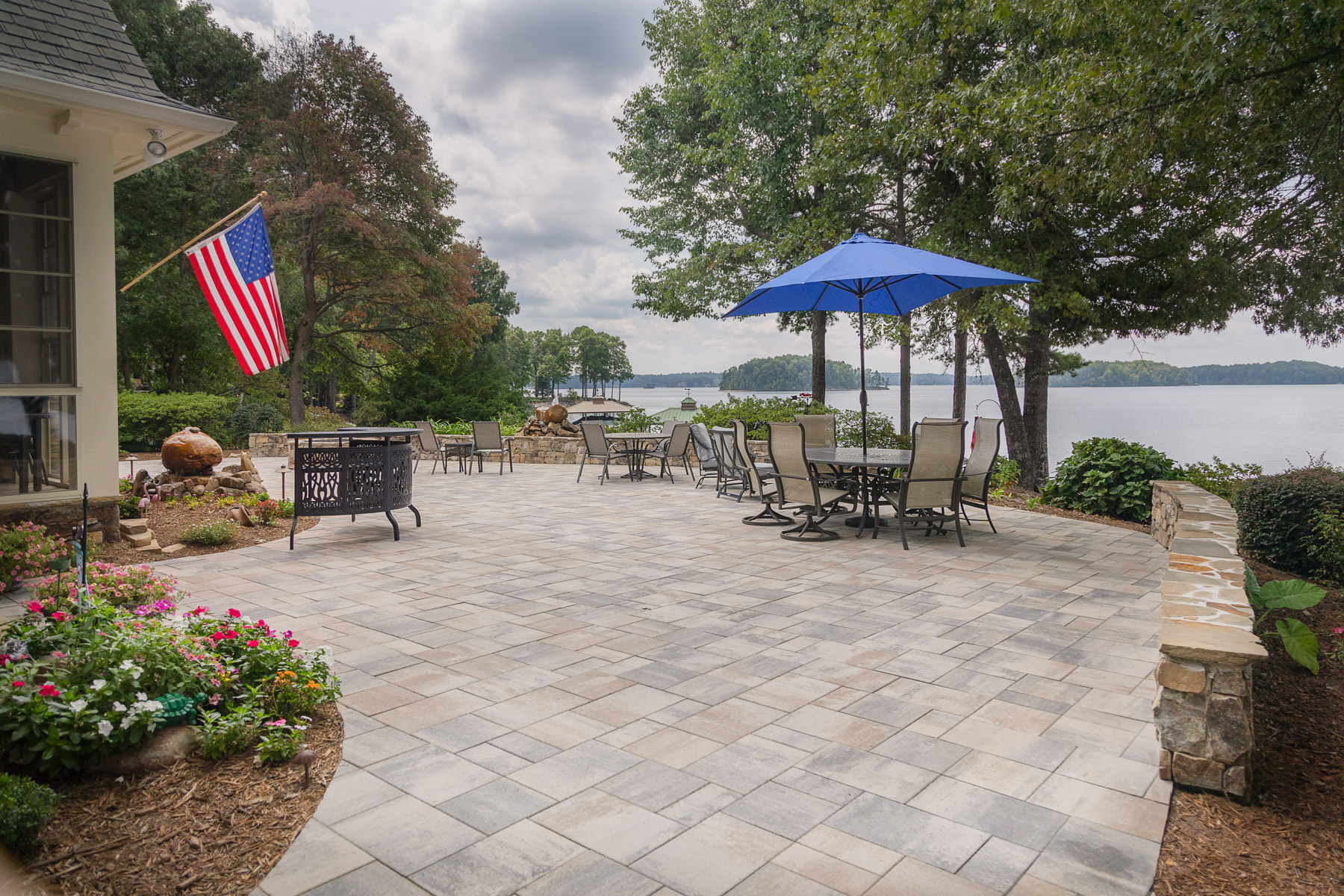 dimensional paver patio umbrella stone wall lake mulch planting beds seating