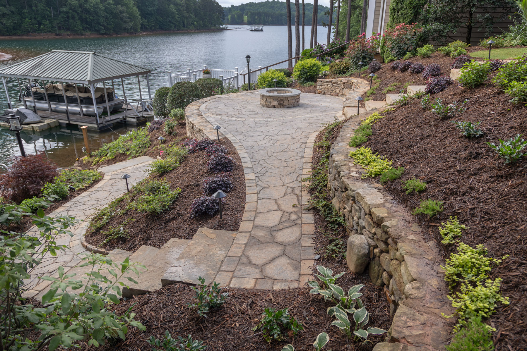 dock pier boat lake stone path steps wall dry stack plants mulch bed fire pit