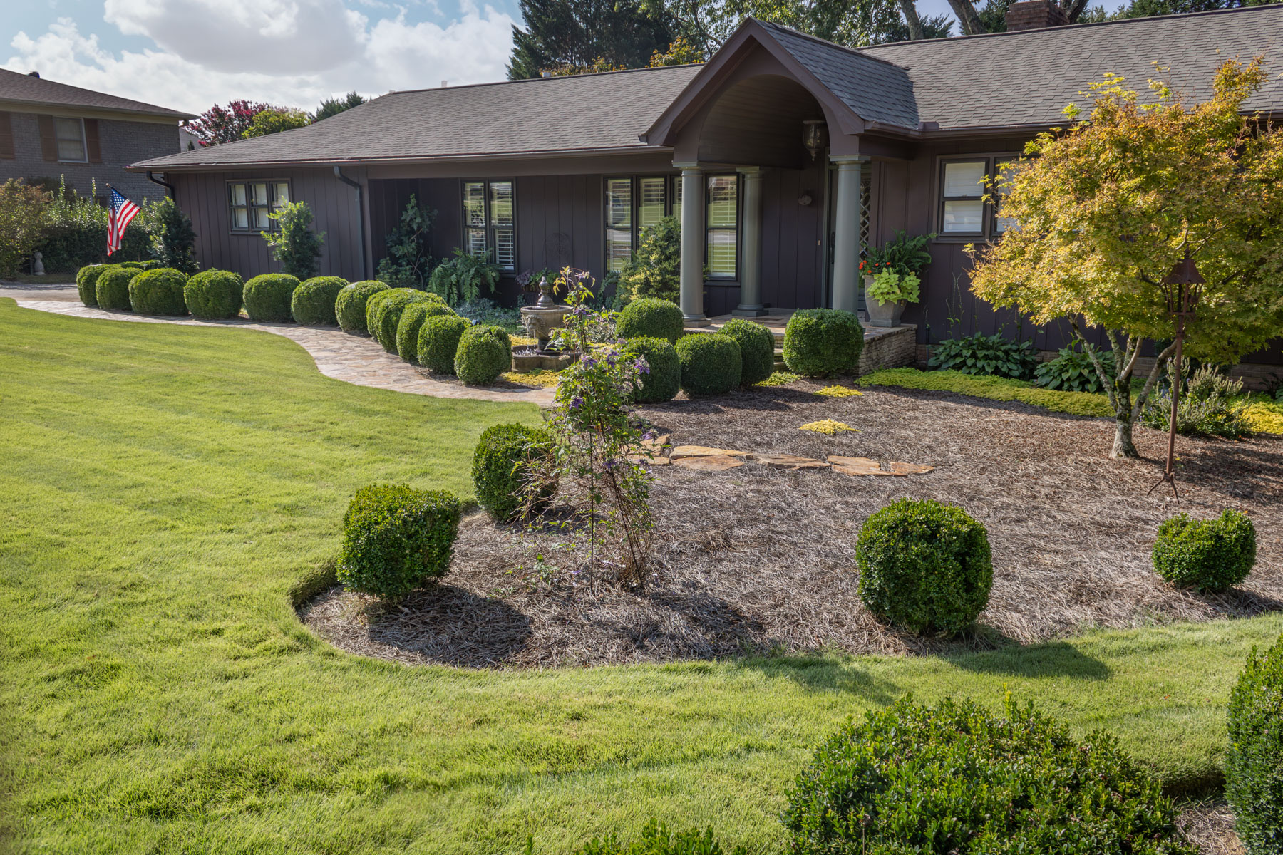 front home planting bed grass shrubs