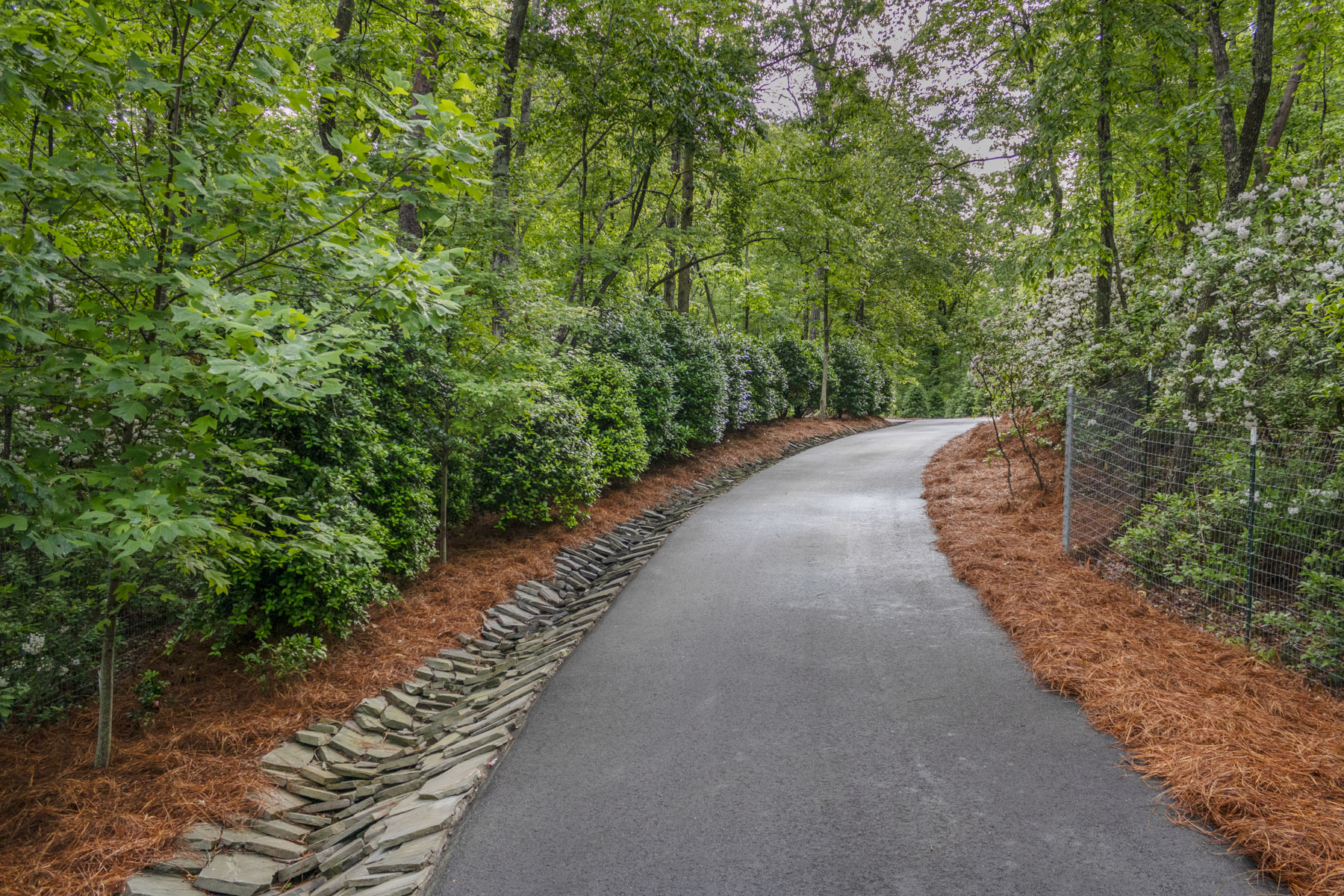 nice driveway dry creek stone boulder wall mulch pine needle fines 6