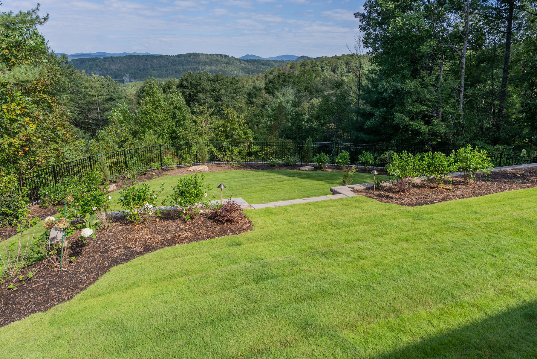 nice green lawn grass beds wall trees