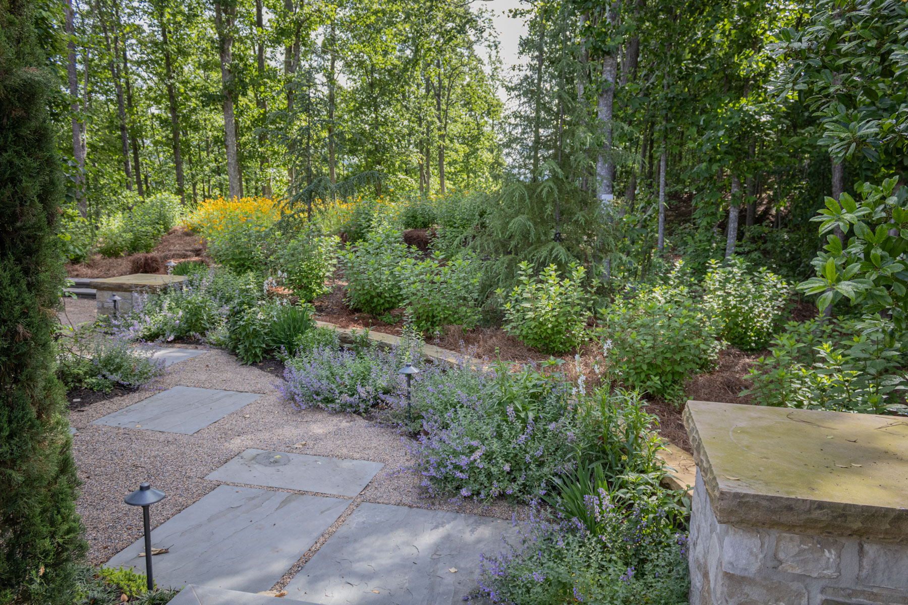 planting beds flowering shgrubs perennials stone path